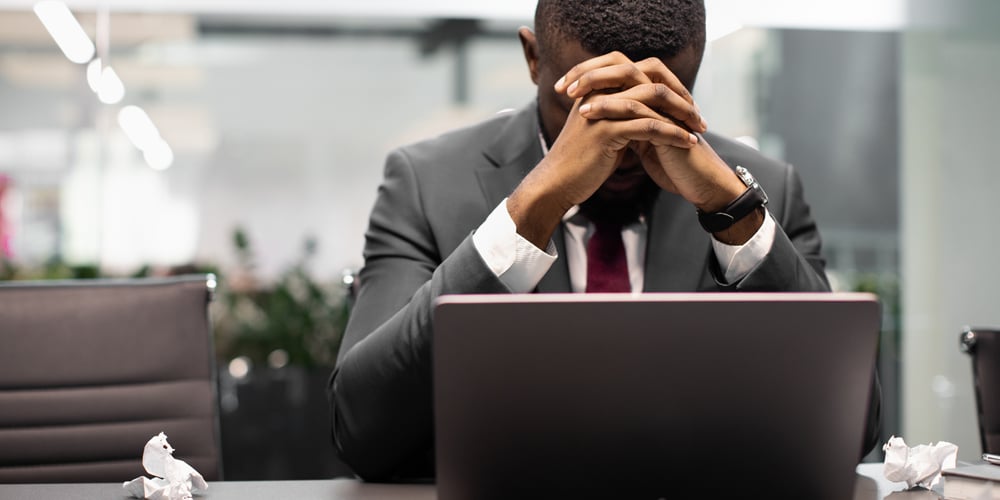 Frustrated employee at his laptop