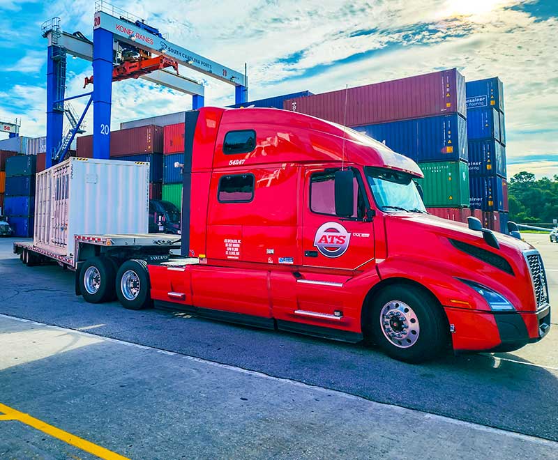 flatbed trailer hauling cargo from port