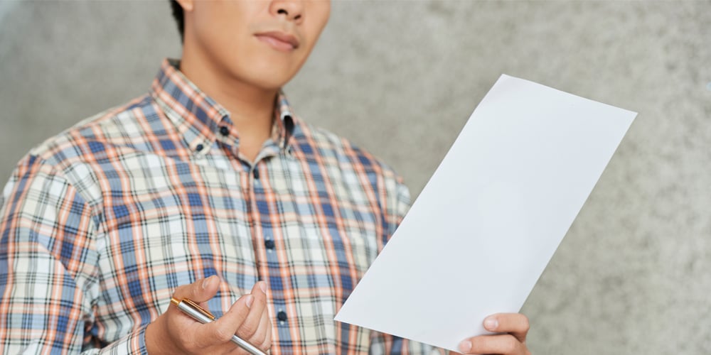 Man proofreading document