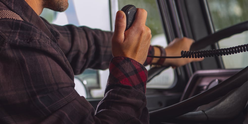 A truck driver uses a CB radio