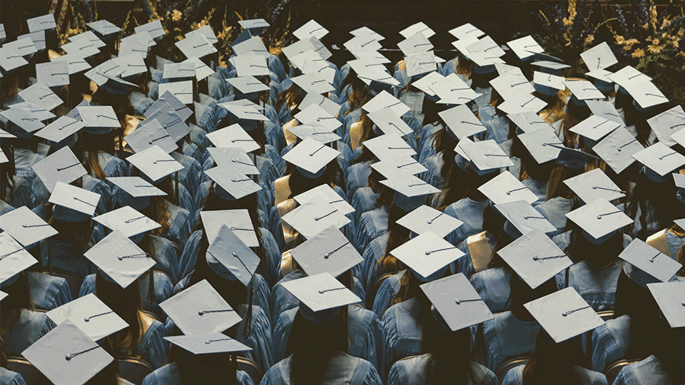 College-Graduates-Sitting-At-Ceremony