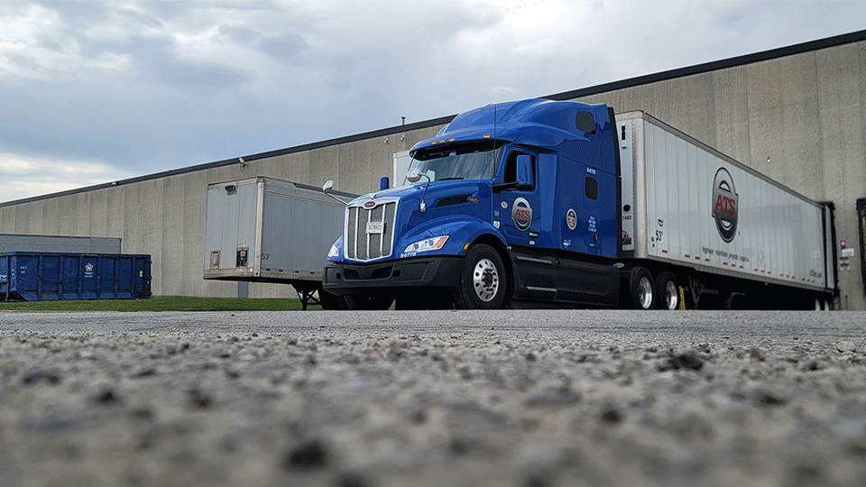Dry van semi truck parked in loading dock
