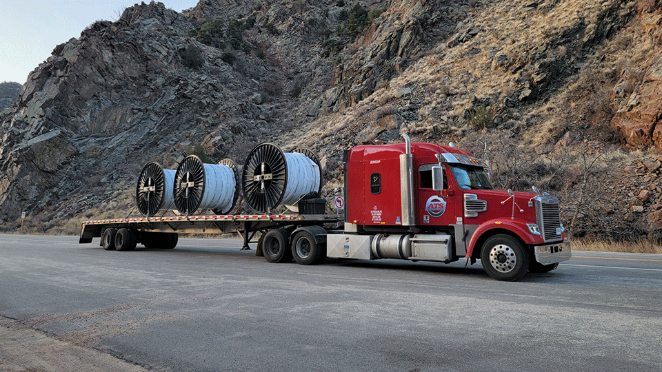 Flatbed trailer with three coils on it