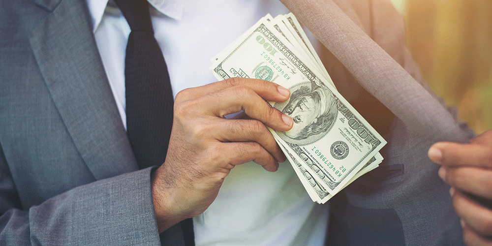 Man-Putting-Money-in-Suit-Jacket