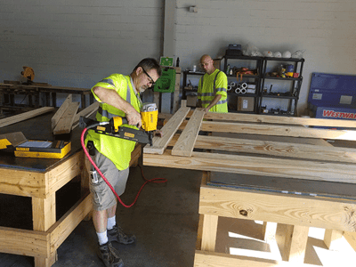 Two men building a crate for packing solutions