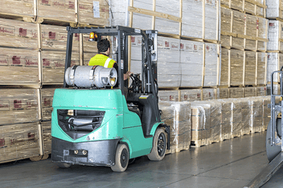 Forklift driving through warehouse