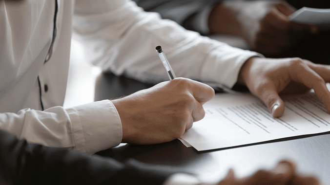 Shipping-document-being-signed-with-pen