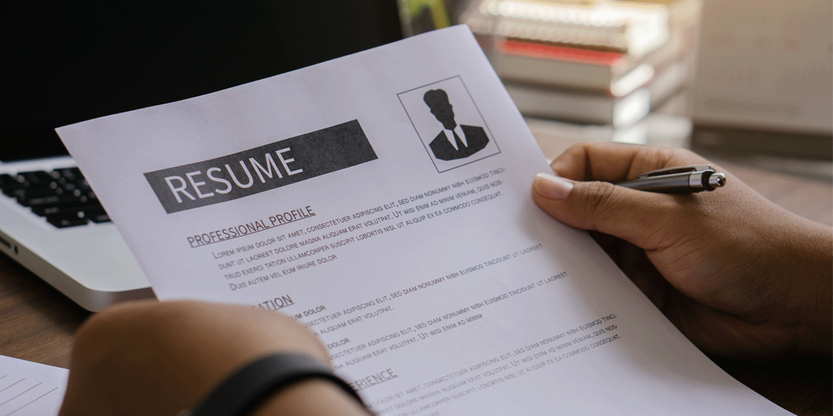 Holding up a resume.