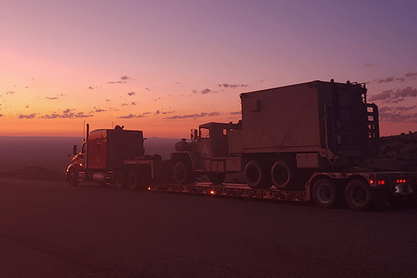 low boy trailer hauling construction equipment