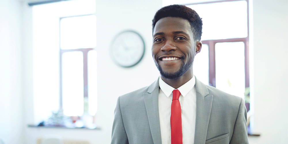 Manager smiling while dressed in professional attire.